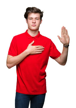 Young handsome man wearing red t-shirt over isolated background Swearing with hand on chest and open palm, making a loyalty promise oath