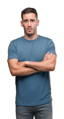 Obraz premium Handsome young casual man skeptic and nervous, disapproving expression on face with crossed arms. Negative person.