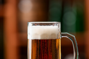 Mug of beer in bar, closeup. Oktoberfest celebration