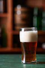 Glass of beer on table in bar. Oktoberfest celebration