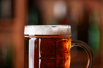 Mug of beer in bar, closeup. Oktoberfest celebration
