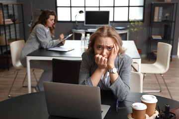 Young woman having panic attack in office
