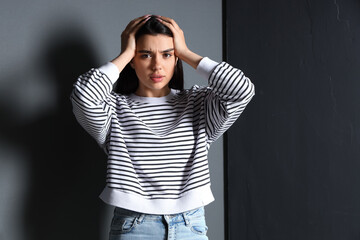 Young woman having panic attack indoors