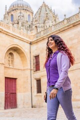 Fototapeta na wymiar Cheerful Latin woman traveler person. Happiness tourist lifestyle in summertime in Spain, Europe