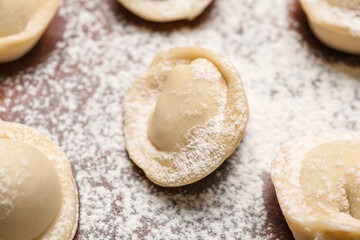 Uncooked dumplings on table, closeup