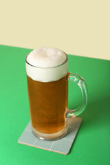 Mug of cold beer on color background