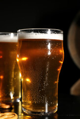 Glasses of cold beer on dark background, closeup