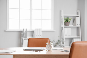 Alarm clock on table in modern office