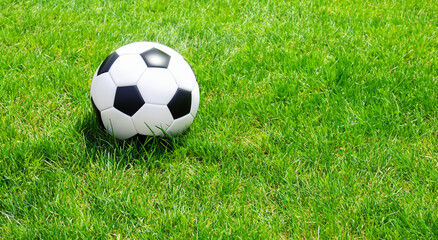 Plakat classic black and white soccer ball on the grass in high resolution and sharpness. soccer concept