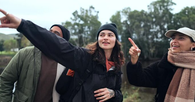 Friends, hiking and people at a lake in nature while calling and pointing at view on journey. Women and a man walking together as a group for a hike, trekking adventure or travel in countryside