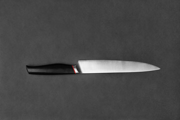 Large kitchen knife on a black background