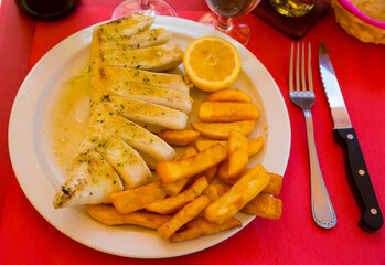 Fried squid served with baked potatoes. High quality photo