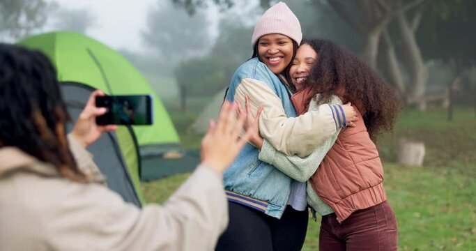 Women friends, photographer and cellphone at camping for hug, care or memory with smile, post and social media. People, profile picture and happy with phone, adventure and holiday in forrest together