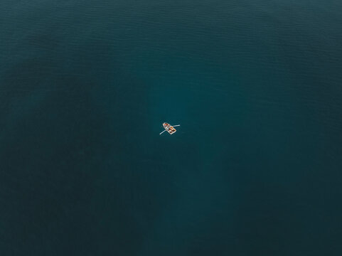 Aerial view of a fisherman's boat in Cefalù bay, Sicily, Italy.