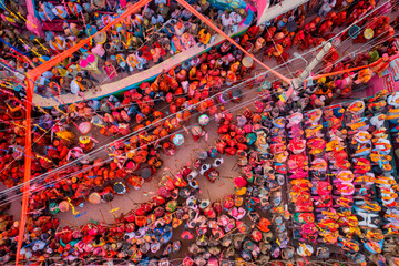 Barsana, India - 28 February 2023: Aerial view of people celebrating the holy colour festival in the street in Barsana, Uttar Pradesh, India.
