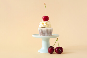Stand with tasty cherry cupcake on beige background - Powered by Adobe