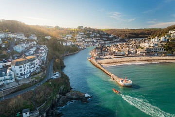 Aerial view of Looe Harbour and Banjo Pier with Looe River and town, Cornwall, United Kingdom.