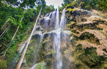 Multiple cascades of the Tumalog Water Falls, pouring into refreshing water pools below,in Oslob,...