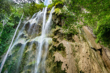 Multiple cascades of the Tumalog Water Falls, pouring into refreshing water pools below,in Oslob,...