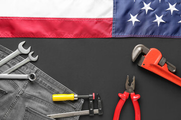 Composition with different tools, jeans and USA flag on black background