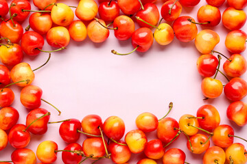 Frame made of sweet yellow cherries on lilac background