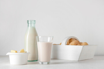 Bottle and glass of tasty potato milk on light background