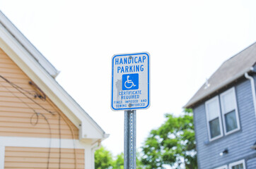 blue wheelchair symbol on a white background. The handicap sign represents accessibility,...