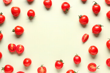 Fototapeta na wymiar Frame made of fresh cherry tomatoes on light green background