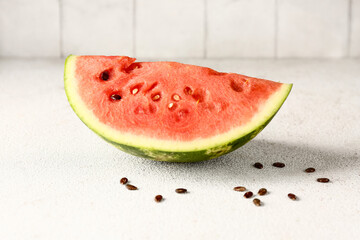 Fototapeta na wymiar Piece of fresh watermelon and seeds on white table