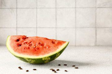 Piece of fresh watermelon and seeds on white table