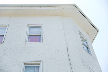 suburban house surrounded by a white picket fence represents the American dream, real estate investment, mortgage obligations, and the impact of inflation on homeowners