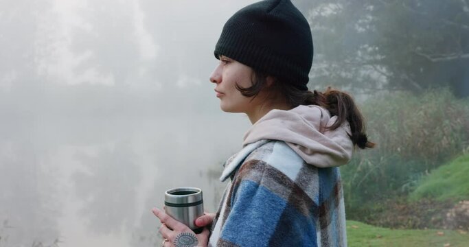 Camping, coffee and woman in nature to relax and be calm on an outdoor holiday, vacation or adventure. Morning, forest and female person enjoy espresso or tea for peace and to explore the woods