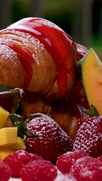 French Toas with strawberries and blueberries on top and drizzled with honey to sweeten the bread. High quality croissant