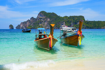 Longtails boats stranded in turquoise waters of Monkey Beach on Koh Phi Phi Don island in the Andaman Sea, Province of Krabi, Thailand
