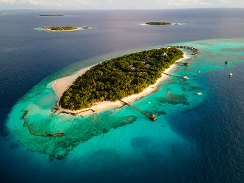 Aerial view of tropical island with water villa, Baa Atoll, Maldives.