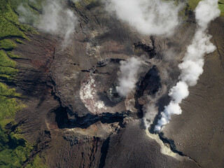 Aerial top down view of smoke coming out of active Gamalama Volcano on Ternate, Indonesia.