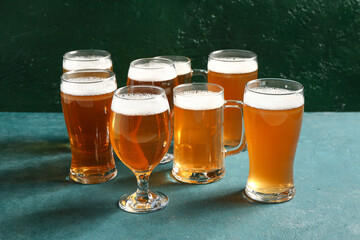 Glasses and mug of cold beer on green background. Oktoberfest celebration