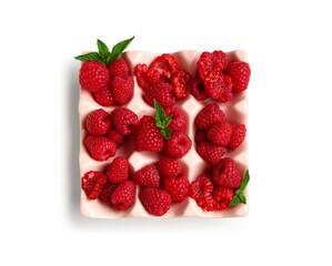 Ice cube tray with fresh raspberries and mint on white background