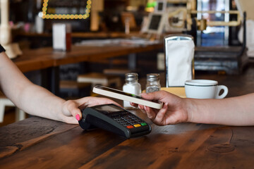Person paying with mobile phone at a restaurant or diner