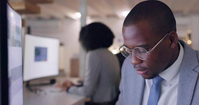 Face, computer and a business black man thinking in the office while working on problem solving at his desk. Technology, glasses and planning with a young male employee reading information online