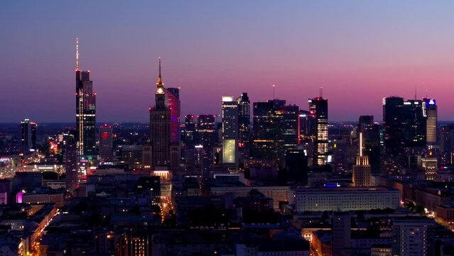 Aerial view of Warsaw Poland, at night. Warsaw business center at night: skyscrapers and Palace of Science and Culture. Drone footage of warsaw center at night. 