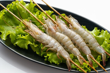 Fresh shrimp skewers on a monochrome background