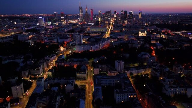 Aerial view of Warsaw Poland, at night. Warsaw business center at night: skyscrapers and Palace of Science and Culture. Drone footage of warsaw center at night. 