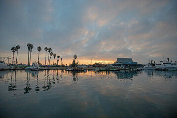 Orange and pink sunrise sky over Channel Islands harbor in Port Hueneme on the gold coast of California United States
