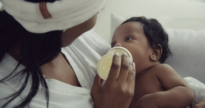 Tender Moments: African Mom Feeding Milk Bottle to Her Baby Boy at Home | Emotional Support and Motherly Love
