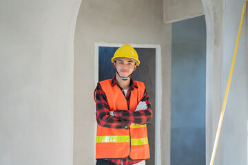 Young construction worker wearing hard hat successful think