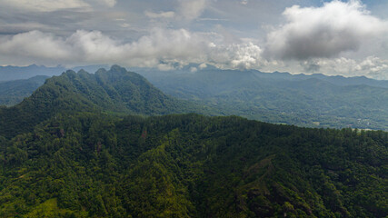 Fototapeta premium Mountains and green hills in Sumatra. Slopes of mountains with evergreen vegetation. Indonesia.