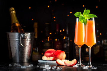 Peach Bellini alcoholic cocktail drink with prosecco, cava, or sparkling wine with peach puree,...