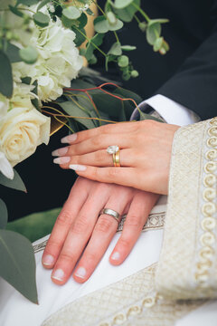 Symbol of eternal love and unity &ndash; bride and groom holding hands with rings and bouquet during wedding ceremony, romance, engagement, devotion, partnership, cultural marriage traditions, romantic mome