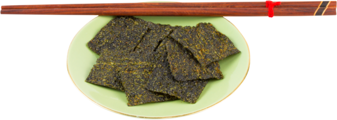 Sheet of dried crispy seaweed in dish with chopsticks